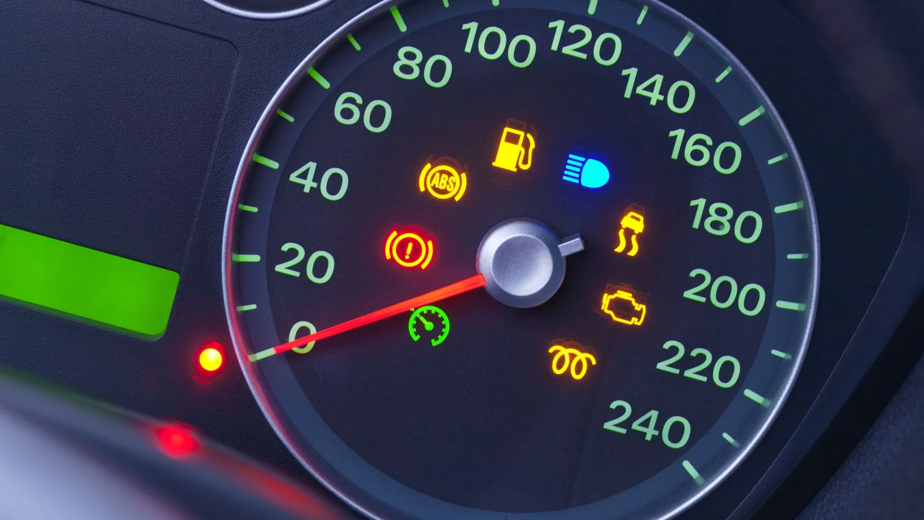 Car dashboard showing multiple warning lights, including oil pressure, brake warning, ABS, and check engine indicators.